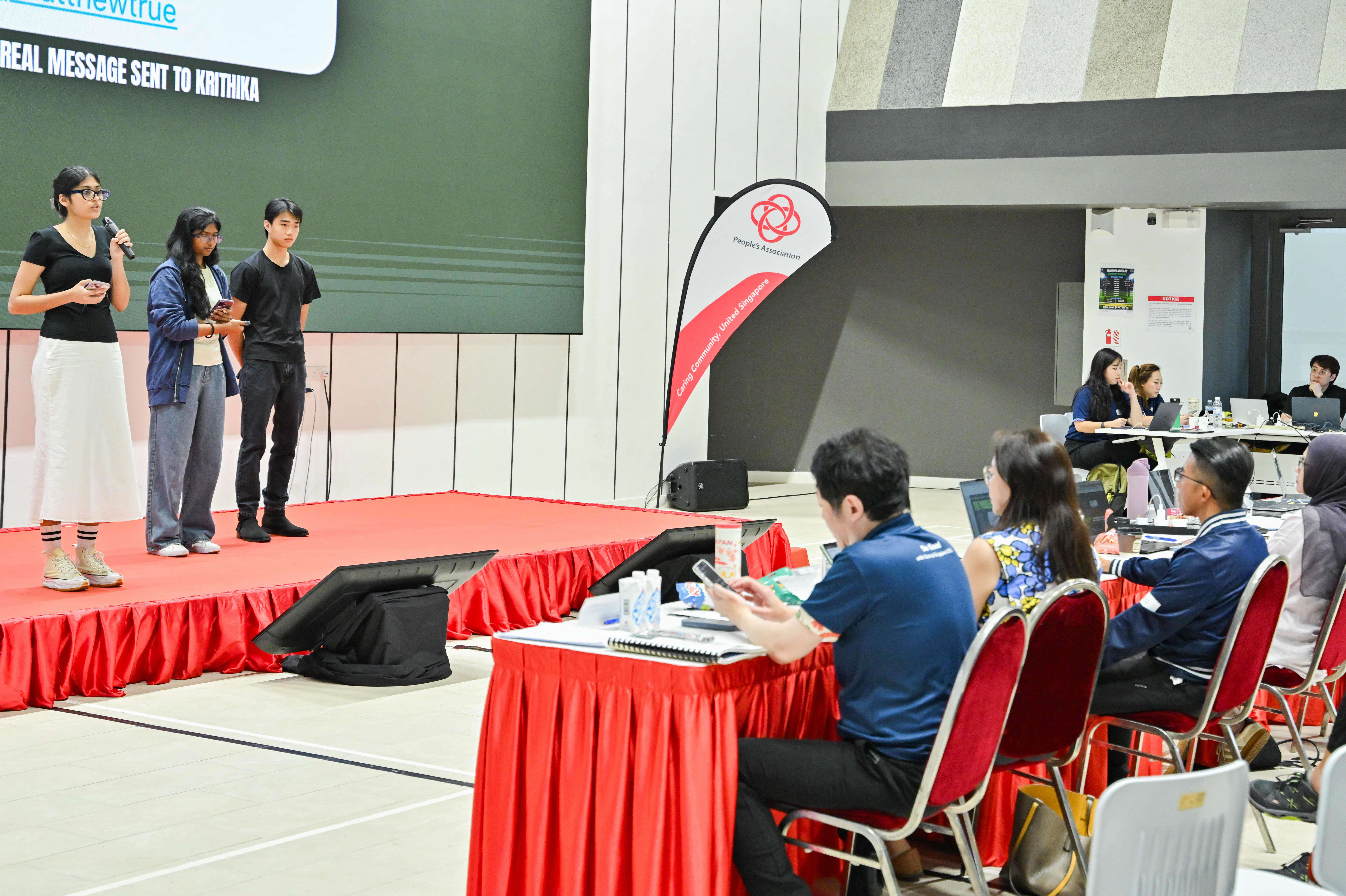 Three students presenting in front of the panel